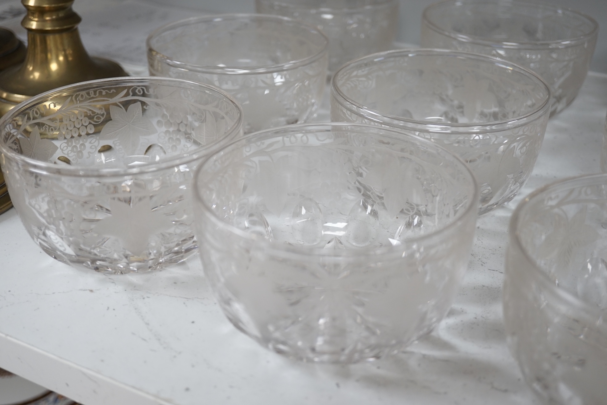 Nine vine engraved glass finger bowls, 13cm diameter. Condition - good.